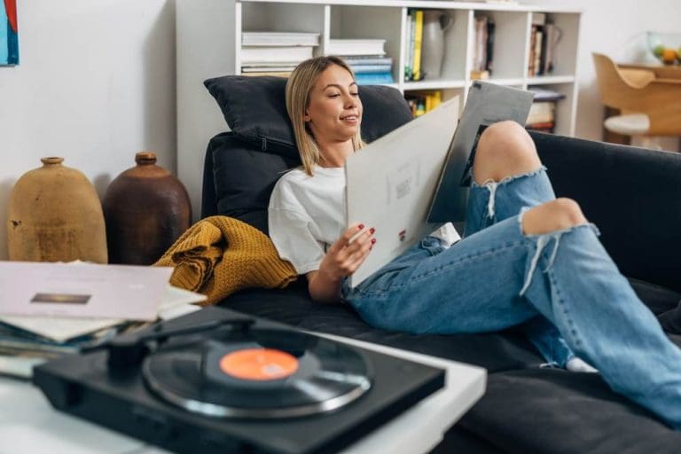 Young woman listening to music on vinyl album cover